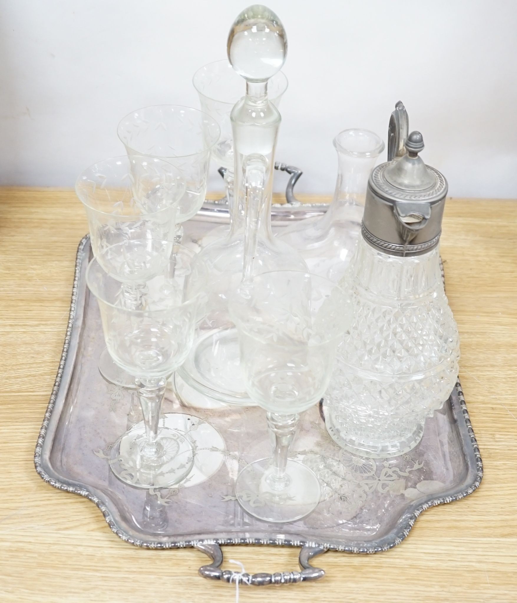 A plated two handled tea tray, a claret jug, two decanters and five glasses (9)